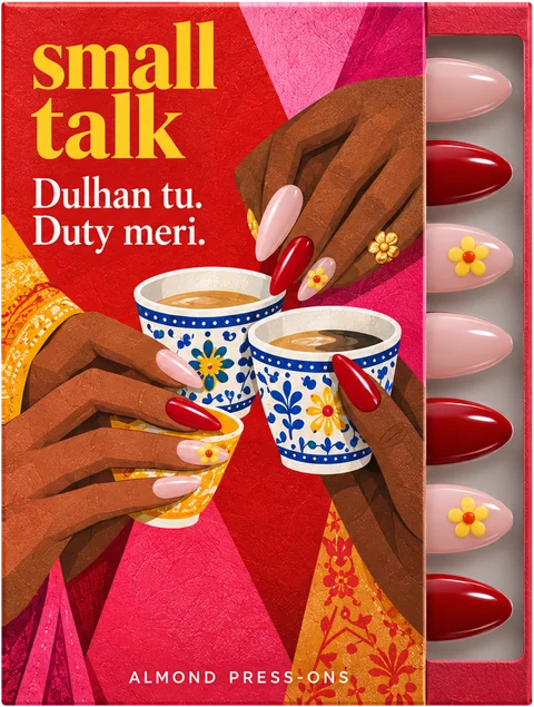 Shaadi Shift press-on nail box by Small Talk, illustrated front, with pink, deep red and yellow-flower nails in the tray.