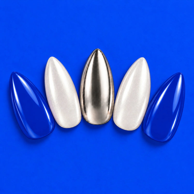 Brainwave press-on nails fanned out on cobalt: cobalt, pearly white and silver almond nails.