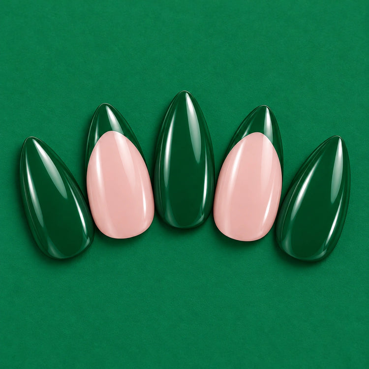 Green Flag press-on nails fanned out on green: emerald, and blush with pointed emerald tips.