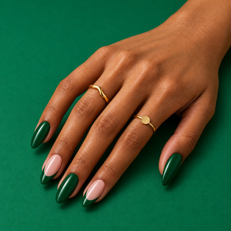 A hand on green wearing Green Flag: emerald, and blush with pointed emerald tips.