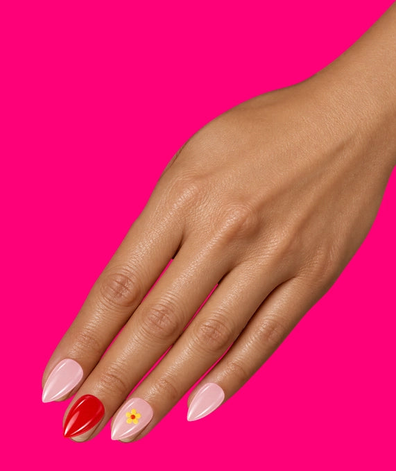 Illustration: a hand on fuchsia wearing the Shaadi Shift set: pink and red nails, one with a little yellow flower.